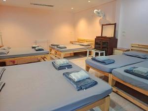 a room with four beds and a mirror at Padang Besar In front of Border Private room & Hostel in Sathani Padang Besa