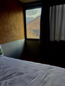 a bedroom with a bed and a window with a view at Berber lodge amssouzart in Tizgui