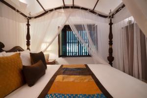 a bedroom with a bed with a canopy at Adigars Manor Kandy - A Boutique Heritage Hotel Built in 1804 in Kandy +116 photos