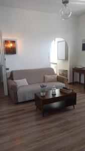 a living room with a couch and a coffee table at Casa Clem centro Menaggio con possibilità di garage in Menaggio