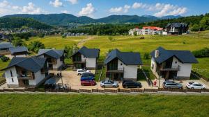 an aerial view of a house with cars parked in a parking lot at Wonder Hill group in Bakuriani