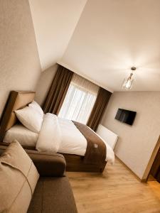 a hotel room with a bed and a window at Wonder Hill group in Bakuriani