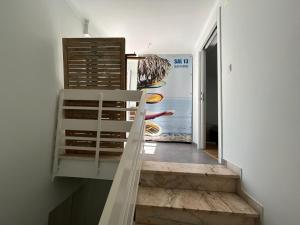 a staircase in a room with a painting on the wall at Sal Guest House in Costa da Caparica