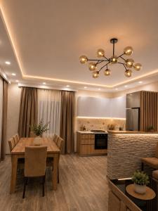 a kitchen and dining room with a dining table and a dining room at Wonder Hill group in Bakuriani