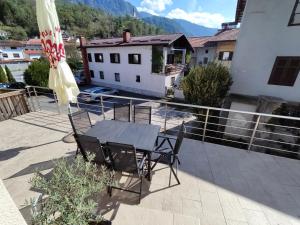 a patio with a table and chairs on a balcony at Apartment MATEA in Kobarid
