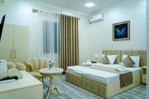 a bedroom with a bed and a living room at Astoria Inn Hotel in Toshkent-Passajir Bekati +36 photos