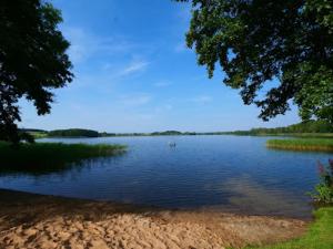 a view of a lake with a boat in the water at Ferienwohnung Kloster Tempzin 19412 in Tempzin