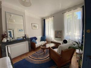 a living room with a couch and a table at Au Jardin in Moissac