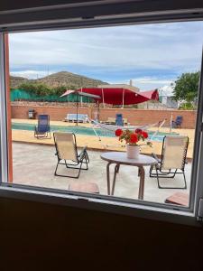 a window with a table and chairs and a pool at Cortijo Maya 2 chambres piscine in Alhama de Almería