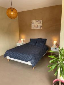 a bedroom with a bed and two night stands at Cortijo Maya 2 chambres piscine in Alhama de Almería