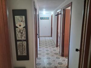 a hallway leading to a room with a tile floor at Mountain View Village Life in Bárig