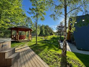 a garden with a gazebo and a park at Cabana Luminis in Râşnov