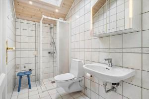 a bathroom with a toilet and a sink at 461-Hvide-Sande-Tingodden-152 in Hvide Sande +33 photos