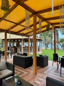 an outdoor patio with couches and tables and chairs at Michael’s Vacancies in Fánai