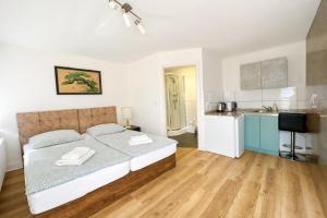 a large bedroom with a bed and a kitchen at Ado Pension in Wedel