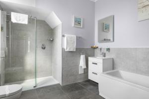 a bathroom with a shower and a toilet and a sink at The Westgate in Torquay +101 photos