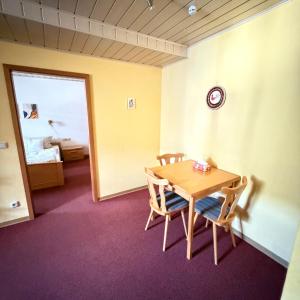 a room with a wooden table and two chairs at Winzerhaus St Joseph in Piesport +14 photos