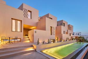 a villa with a swimming pool and a house at Enorme EOS Santorini - Adults Only in Pyrgos +77 photos