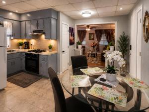 a kitchen and dining room with a table and chairs at Fall River Stay Urban Haven Entire Suites Cozy 4BR in Fall River