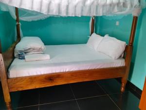 a bed in a room with a canopy bed at Chwele Premier Resort in Bungoma