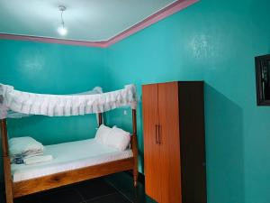 a bedroom with two bunk beds in a room at Chwele Premier Resort in Bungoma