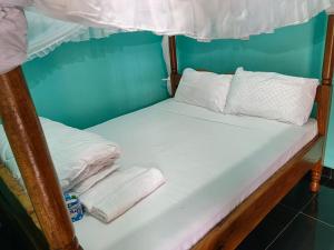two bunk beds in a room with towels at Chwele Premier Resort in Bungoma