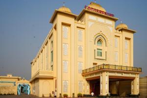 a large building with a balcony on top of it at Lotus Resort in Raipur