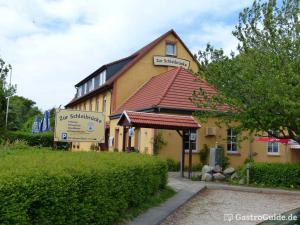 a building with a sign in front of it at Zur Schleibrücke in Boren