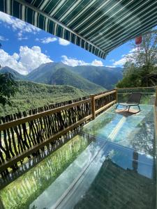 a swimming pool with a view of mountains at Siguniang Mountain Lanxi Wild Luxury Hotel in Mount Siguniang