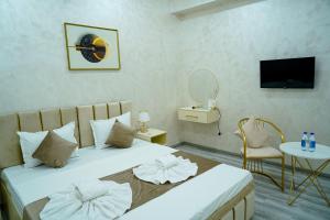 a hotel room with a bed and a tv at Astoria Inn Hotel in Toshkent-Passajir Bekati