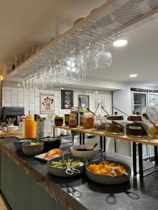 a kitchen with many plates of food on a counter at Alma Candida 01 in Valença