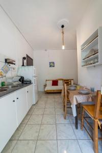 a kitchen and dining room with a table and a dining room at Apartment's Eleni in Kamena Vourla