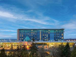 a large building with lights on in front of it at Fairmont Vancouver Airport In-Terminal Hotel in Richmond