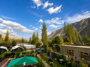 a view of a yard with a tent and mountains at Hotel Nubra Delight and Camps in Hundar