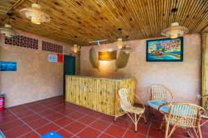 a restaurant with a table and chairs in a room at Mango Village in Phú Quốc