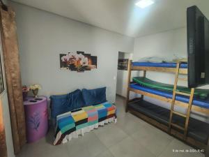 a room with two bunk beds and a television at Casa com piscina, aconchegante, aceita pet in Cotia +18 photos