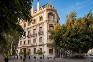a large white building with a lot of windows at Áurea Palacio de la Tinta by Eurostars Hotel Company in Málaga