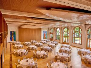 a banquet hall with white tables and chairs at Fairmont Le Montreux Palace in Montreux +228 photos