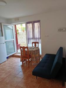 a living room with a table and chairs and a couch at Apartamentos Arredondo in Arredondo