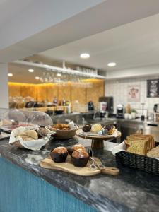 a counter with several trays of pastries on it at Alma Candida 22 in Valença