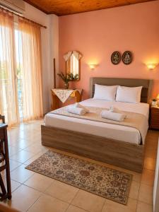 a bedroom with a large bed in a room at Annamaria Studios & Apartments in Petra +15 photos