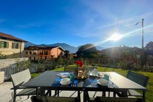 a table on a patio with the sun in the background at Condominio Modern House in Menaggio +81 photos