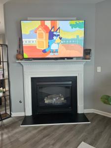 a fireplace with a television on top of it at Spacious 3 bedroom 3 bathroom cozy home with patio 15 mins away from ATL in Decatur