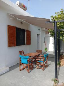 a patio with a table and chairs and a tv at Summer House 96 in Salamina
