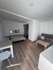 a living room with a couch and a table at Apartamentos Canoa centro y playa in Sanlúcar de Barrameda +6 photos