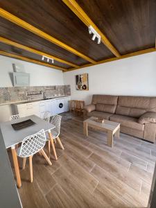 a living room with a couch and a table at Apartamentos Canoa centro y playa in Sanlúcar de Barrameda
