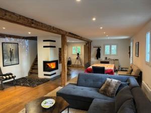 a living room with a couch and a fireplace at Chalet for 10 with the forest in Séranon