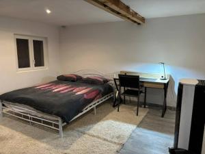 a bedroom with a bed and a desk and a table at Chalet for 10 with the forest in Séranon
