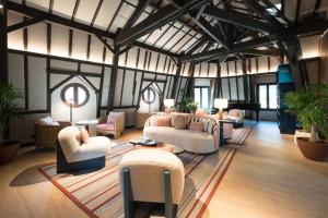a living room with couches and chairs and tables at Áurea Palacio de la Tinta by Eurostars Hotel Company in Málaga
