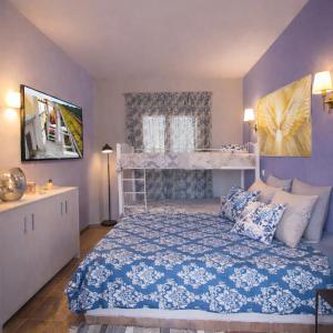 a bedroom with a bed with a blue comforter at Angelparadise village stefani in Stefáni